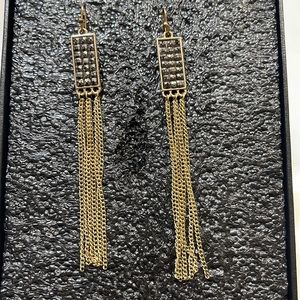 Gold earring with some black sparkles